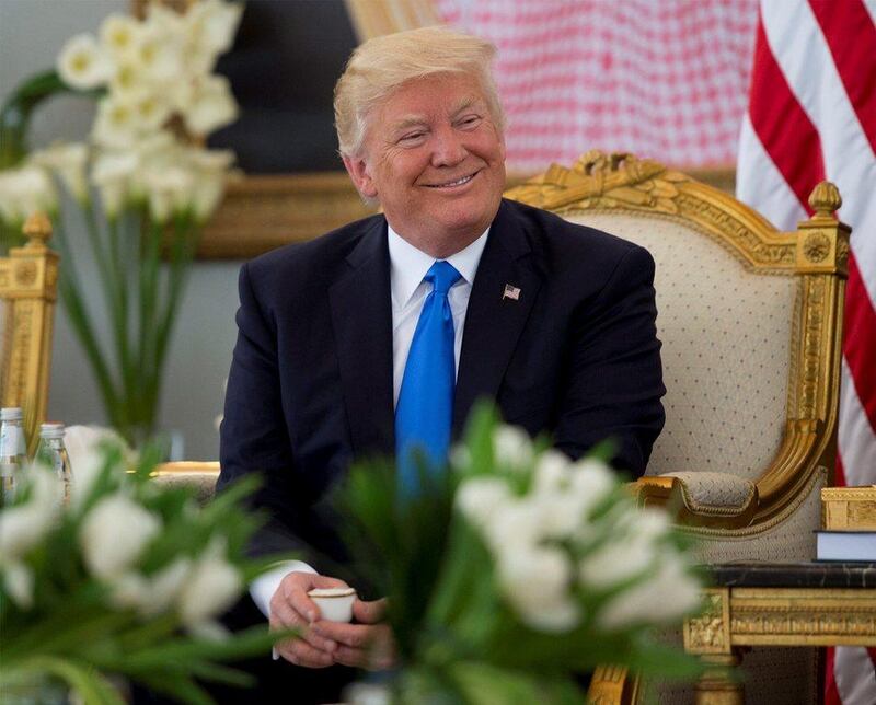 Donald Trump enjoys a coffee during a reception ceremony. Saudi Royal Court / Handout via Reuters