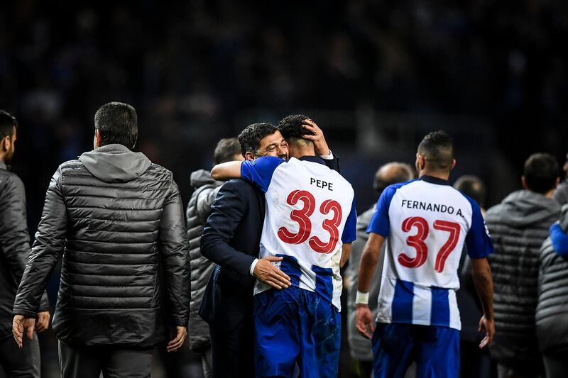 Porto manager Sergio Conceicao, centre-left, celebrates winning with defender Pepe at the end of their Uefa Champions League last-16 second-leg win over Roma. Patricia de Melo Moreira / AFP