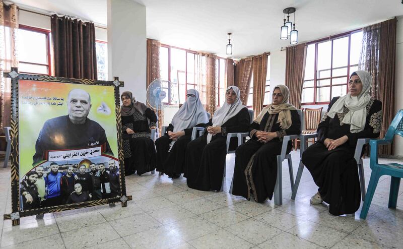 Family members of Saadi sl Ghrabli, pictured, a Palestinian sentenced and imprisoned by Israel for life for murder 26 years ago, mourn together during his death anniversary in Gaza City. He died while receiving treatment for cancer at an Israeli hospital in Tel Aviv.   AFP