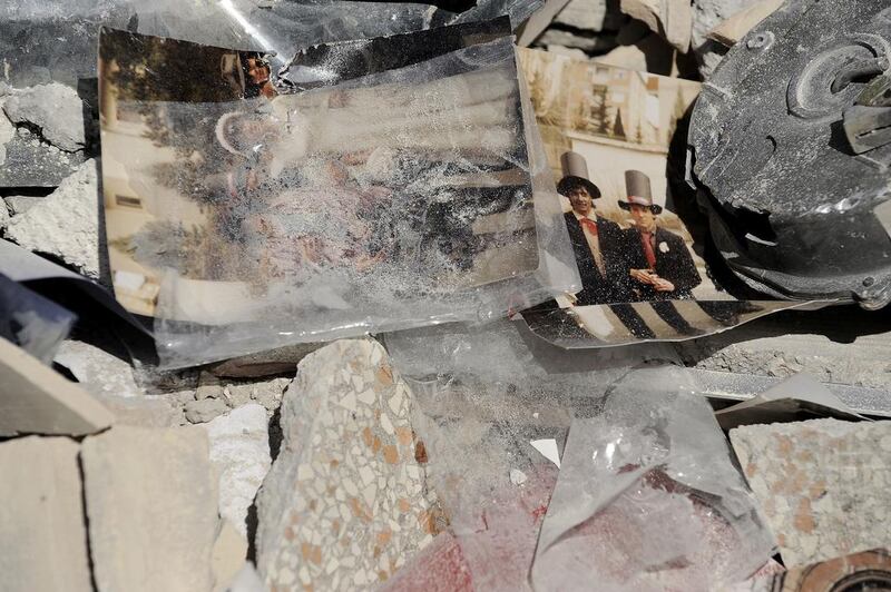 Family photos lie among the debris after the 6.3 magnitude earthquake which struck L’Aquila, Abruzzo, Italy, on April 6, 2009, killing hundreds of people. The tragedy is the catalyst for Donatella Di Pietrantonio’s second novel Bella Mia. Filippo Monteforte / AFP. 