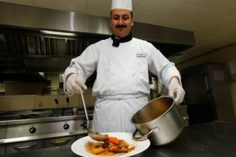 Dubai, 12th September 2011.  Nashat Abdulla (Oriental Chef) preparing an Emirati main dish Hares (lamb with gee), at Cassells Hotel.  (Jeffrey E Biteng / The National)