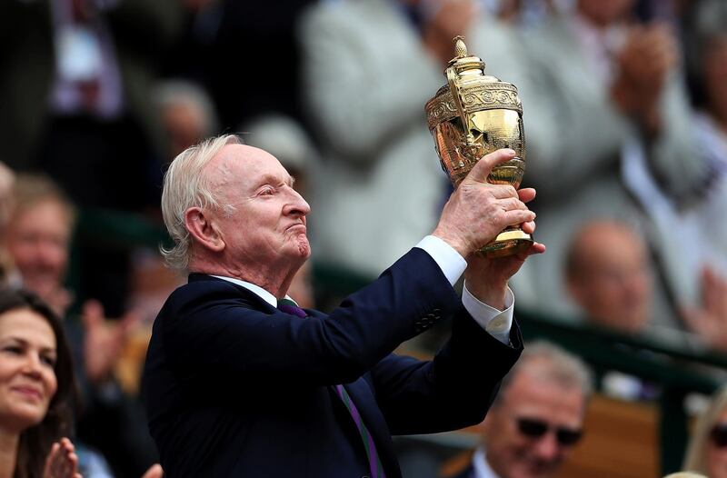 Former Wimbledon champion Rod Laver holds up the mens singles championship trophy. PA