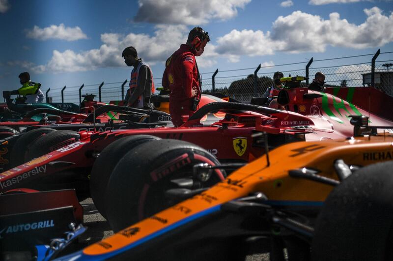 Technicians inspect their cars after the qualifying session of the Formula One Portuguese Grand Prix, at the Algarve International Circuit in Portimao. AFP