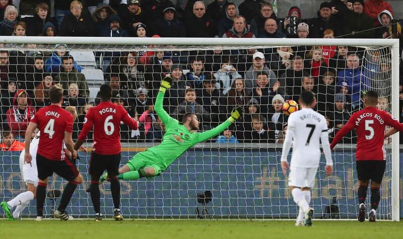 Manchester United’s David de Gea dives but fails to save a shot. Geoff Caddick / AFP