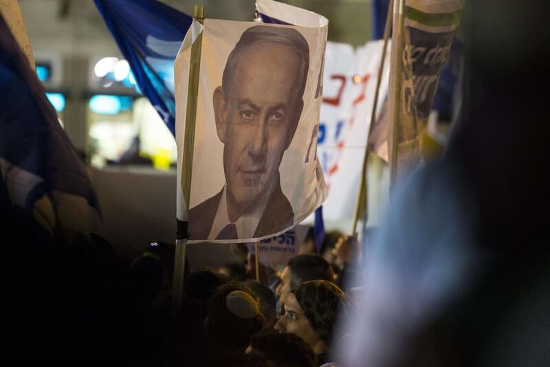 Supporters of Israeli prime minister Benjamin Netanyahu carry posters bearing his portrait during a campaign meeting on March 15 in Tel Aviv. AFP Photo