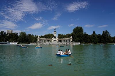 People enjoy boat rides on a lake at El Retiro Park in Madrid. Reuters