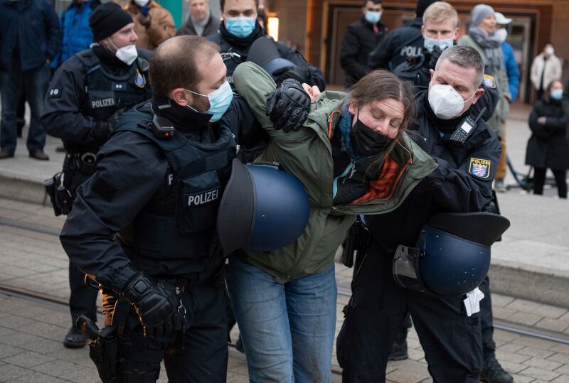 A protester being detained during a demonstration against Covid-19 measures in the German city of Frankfurt. AP Photo