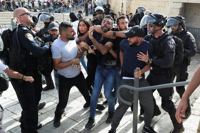 A Palestinian man is detained by undercover and uniformed Israeli security force members as Israelis mark 'Jerusalem Day', near Damascus Gate, just outside Jerusalem's Old City. Reuters