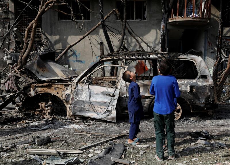 Afghan boys look the site of Sunday's attack in Kabul, Afghanistan July 29, 2019. REUTERS/Mohammad Ismail