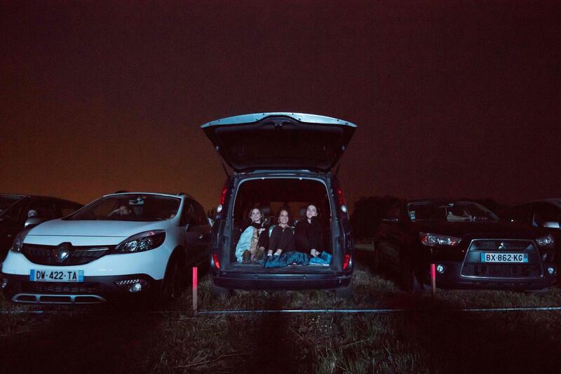 People watch a movie from their cars at a drive-in theatre in Les Herbiers, western France as France eases lockdown measures. AFP