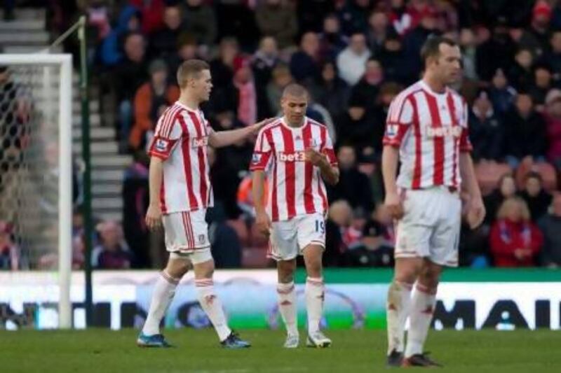 Stoke's Jonathan Walters, centre, is consoled by his captain Ryan Shawcross after scoring an own goal during his team's 4-0 loss to Chelsea on Saturday.