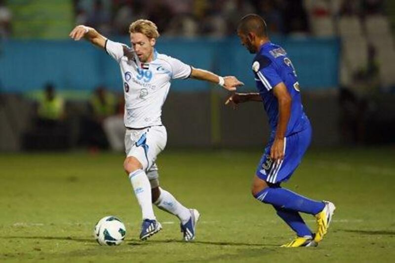 Baniyas’ Christian Wilhelmsson, left, gets past Al Khor‘s Abdulrahman Al Hajaj during the Gulf Clubs Championship on Thursday night. Jake Badger for The National.