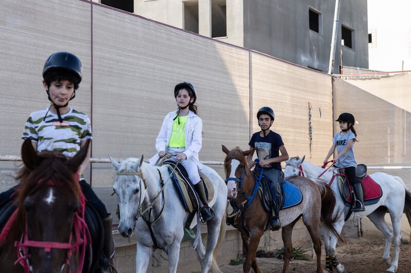 Children practise horse riding at Friends Equestrian Club.