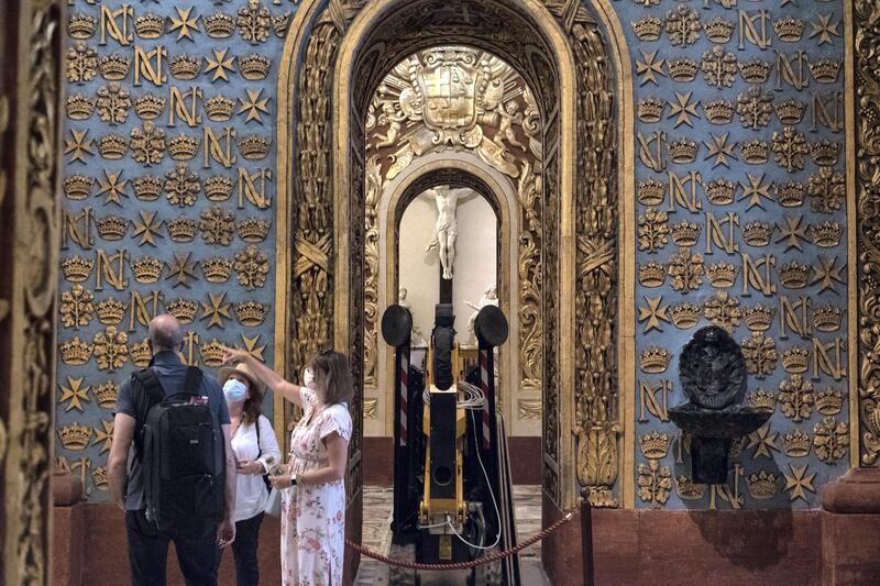 VALLETTA, MALTA - JUNE 01: Two tourists are guided by a woman inside St.John's Co-Cathedral on June 1, 2021 in Valletta, Malta. From June 1, Malta will reopen its doors to tourism, allowing passengers holding vaccine certificates or those who can present a negative coronavirus test before traveling to the Mediterranean island. Nearly 70 per cent of Malta's adults have received one vaccine dose, yet the virus is still circulating on the island, with some 42 per cent of the population fully inoculated against Covid-19.  (Photo by Joanna Demarco/Getty Images)