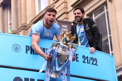 Manchester City's Ruben Dias lifts the Premier League trophy with Bernardo Silva in May. Getty Images