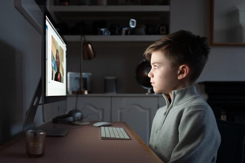 LONDON, ENGLAND - JANUARY 05: The son of the photographer begins the new school term of 2021 at home by watching an online introduction from his teacher, on January 05, 2021 in London, England. All primary and secondary schools have now closed until at least mid-February, with GCSE and A-level exams facing cancellation for a second year. British Prime Minister made a national television address on Monday evening announcing England is to enter its third coronavirus lockdown of the year. On Monday the UK recorded more than 50,000 new confirmed Covid cases for the seventh day in a row. (Photo by Leon Neal/Getty Images)