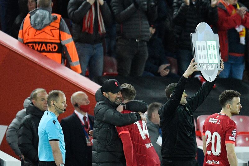 Liverpool manager Jurgen Klopp hugs Jordan Henderson as he leaves the pitch. AFP