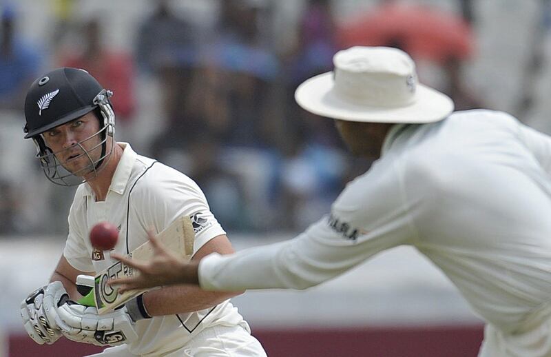 New Zealand cricketer James Franklin (L) plays a shot as Indian cricketer Virender Sehwag (R) reacts during the third day of the first Test match between India and New Zealand at the Rajiv Gandhi International Cricket Stadium in Hyderabad on August 25, 2012. AFP PHOTO / Noah SEELAM
 *** Local Caption ***  306280-01-08.jpg