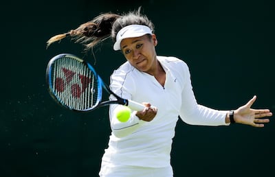Japan's Naomi Osaka returns the ball at a practice session ahead of the Wimbledon Tennis Championships in London Saturday, June 29, 2019. The Wimbledon Tennis Championships start on Monday, July 1 and run until Sunday, July 14, 2019. (AP Photo/Ben Curtis)