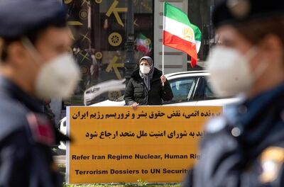 A woman attends a protest of the National Council of Resistance of Iran, an Iranian opposition group, in front of the 'Grand Hotel Wien' during the closed-door nuclear talks with Iran in Vienna on April 9, 2021, where diplomats of the EU, China, Russia and Iran held their talks.  The US participates in discussions in Vienna to try to save the international agreement on Iranian nuclear power. However, they don't meet at the same table as Tehran and it is the Europeans who will serve as intermediaries between the two parties, in the hope of achieving concrete results after two months of impasse. / AFP / JOE KLAMAR
