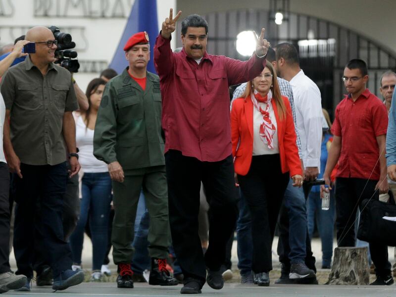 Venezuela's President Nicolas Maduro makes the victory sign after voting in presidential elections in Caracas, Venezuela. Ricardo Mazalan / AP Photo
