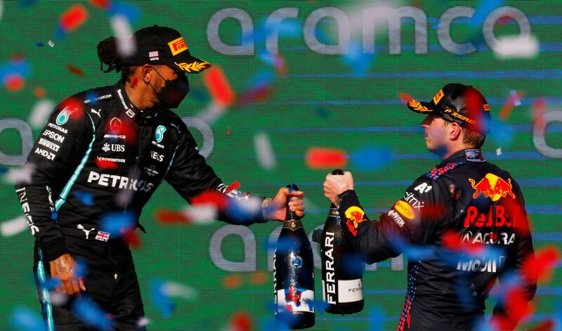 Red Bull's Max Verstappen, right, celebrates on the podium after winning the United States Grand Prix alongside second-place Lewis Hamilton of Mercedes. Reuters