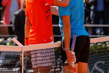 Novak Djokovic and Dominic Thiem greet each other at the net following their French Open semi-final. AP Photo