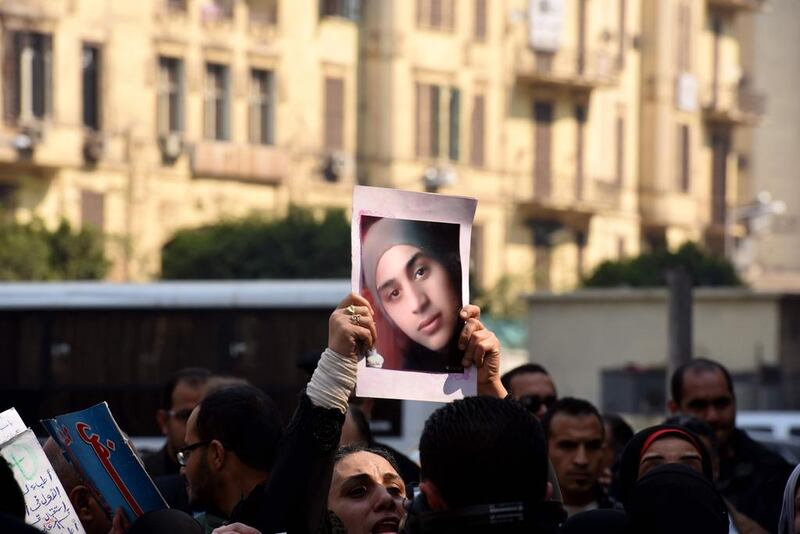 An Egyptian woman holds a portrait of a family member and a victim of the Port Said massacre outside the Court of Cassation following the court's ruling in Cairo, on February 20, 2017, where it upheld death sentences against 10 people convicted over the 2012 rioting that claimed 74 lives. Mohamde El Shahed/AFP 