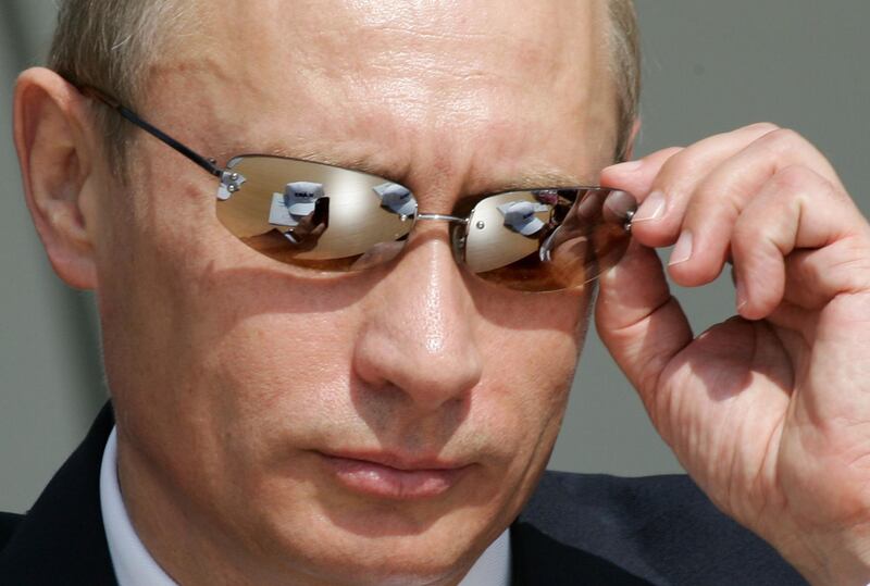 Putin adjusts his sunglasses during the MAKS-2005 International air and space show in Zhukovsky on August 16, 2005. AFP