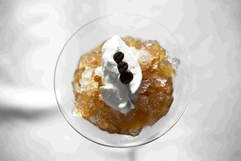 Coffee granita desert, which is a simple mix of ice and syrup, topped with whipped cream.