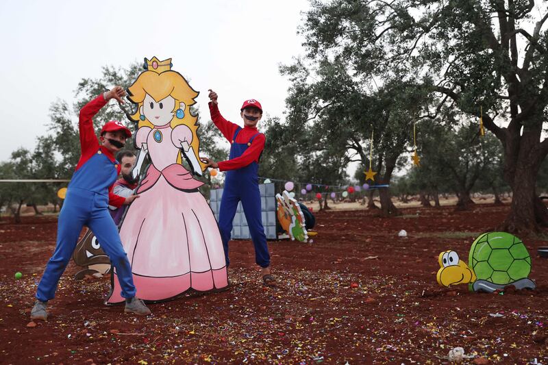 Children play on Eid Al Fitr at a displaced persons camp in the village of Killi in Syria's rebel-held north-western city of Idlib. AFP