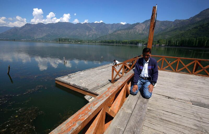 A Kashmiri Muslim man offers prayers on the banks of Dal Lake amid Covid-19 lockdown in Srinagar, the summer capital of Indian Kashmir. EPA