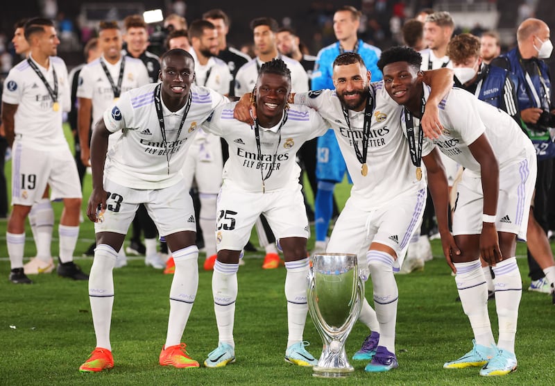 Ferland Mendy, Eduardo Camavinga, Karim Benzema and Aurelien Tchouameni of Real Madrid pose for a photograph with the Uefa Super Cup trophy after a 2-0 win over Eintracht Frankfurt at Helsinki Olympic Stadium on August 10, 2022 in Helsinki, Finland. Getty Images