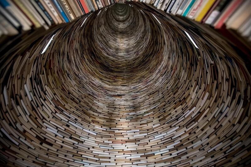 Books are piled up into a sculpture titled 'Idiom' by Slovak artist Matej Kren, a column made of 8,000 books, at the entrance of the Central Library in Prague, Czech Republic. EPA