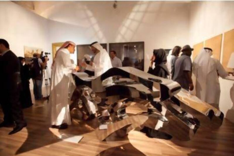 Visitors beside the work "Depth & Speed" by Matter bin Lahed (UAE) at the expo "25 years of Arab Creativity" - part of the 10th year anniversary of the Abu Dhabi Festival at Emirates Palace. Jaime Puebla / The National