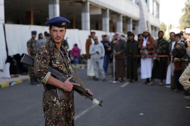 A soldier stands guard at the airport during the arrival of Houthi prisoners released by the Saudi-led coalition, in Sanaa, Yemen, on November 28, 2019. AP