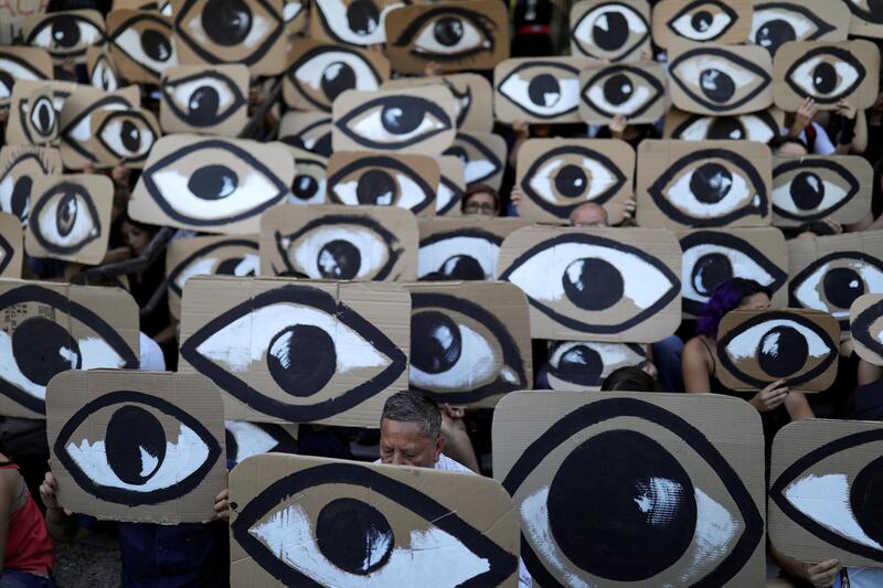 Demonstrators hold placards during a protest against Chile's government, in Santiago, Chile.  Reuters