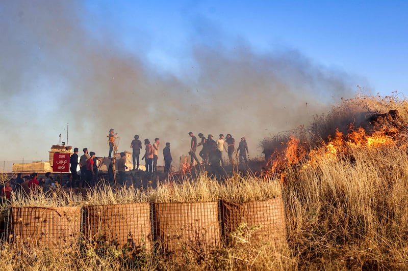 A fire burns near the protest at a Turkish army observation point in Ibbin Samaan. AFP