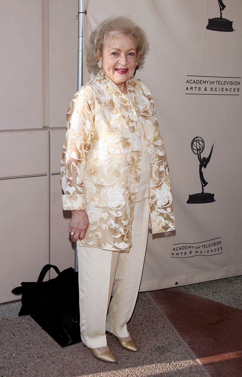 Betty White, in a repeated sheer floral jacket over a tan two-piece with glittering earrings, arrives at the Academy of Television Arts and Sciences celebrating her 60 years in television at the Leonard Goldenson Theatre on August 7, 2008. AFP