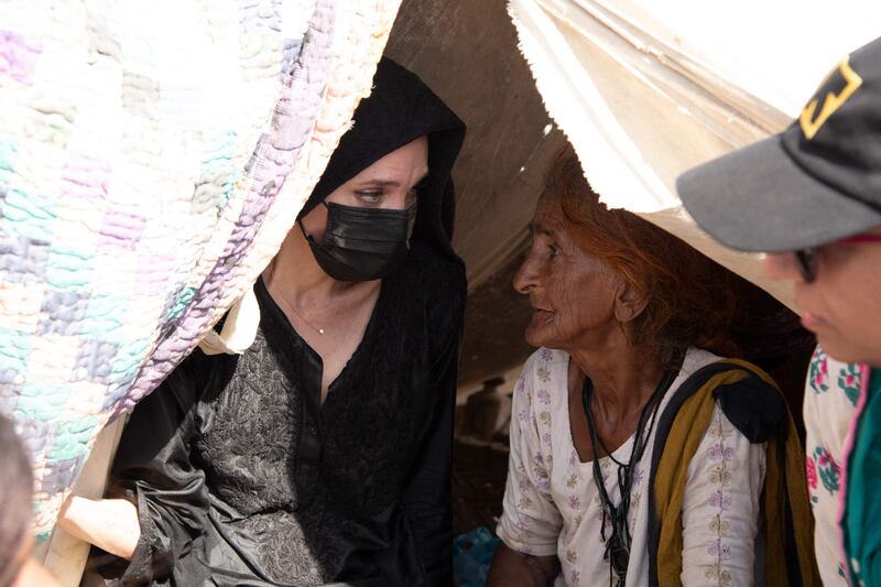 Actress and humanitarian Jolie meets a flood victim at a makeshift shelter during her visit to Ibrahim Chandio village at Johi town in Dadu district, Sindh province in Pakistan. AFP