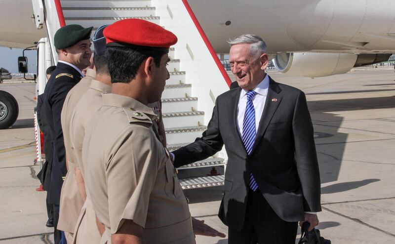 US Secretary for Defense Jim Mattis (R) shakes hands with Omani officials upon his arrival in the capital Muscat on March 11, 2018. / AFP PHOTO / Thomas WATKINS