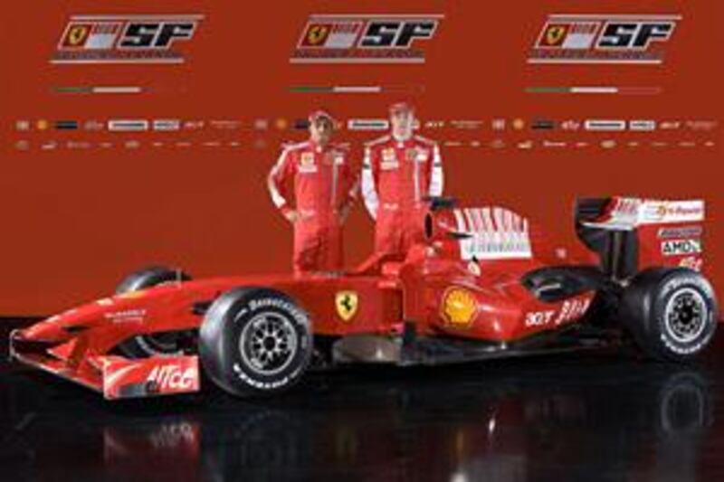 Ferrari drivers Felipe Massa, left, and Kimi Raikkonen pose with the new Ferrari F60.
