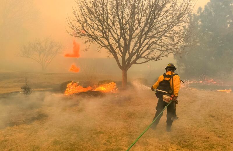 A handout photo made available by the Flower Mound Fire Department shows firefighters with the Flower Mound Fire Department out of Flower Mound, Texas, helping to contain a wildfire in the panhandle region of Texas, USA, 27 February 2024 (issued 28 February 2024).  The fire is affecting 500,000 acres of land and is the second largest fire in Texas history.   EPA / FLOWER MOUND TEXAS FIRE DEPARTMENT HANDOUT  HANDOUT EDITORIAL USE ONLY / NO SALES HANDOUT EDITORIAL USE ONLY / NO SALES