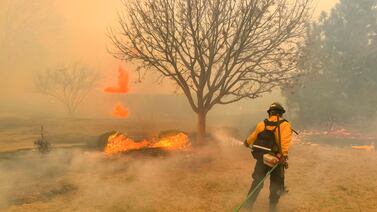 A firefighter works to try to contain a wildfire in the panhandle region of Texas. Reuters