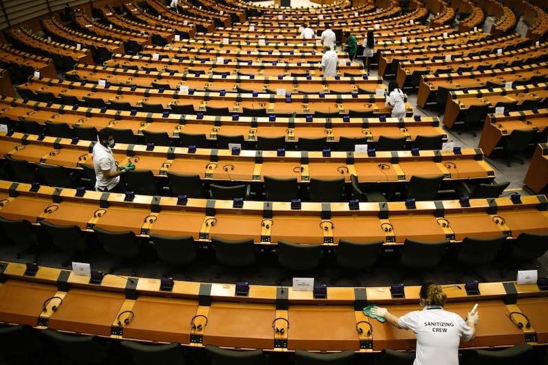 Members of a sanitising crew clean the hemicycle  ahead to plenary session of the European Parliament in Brussels.   AFP