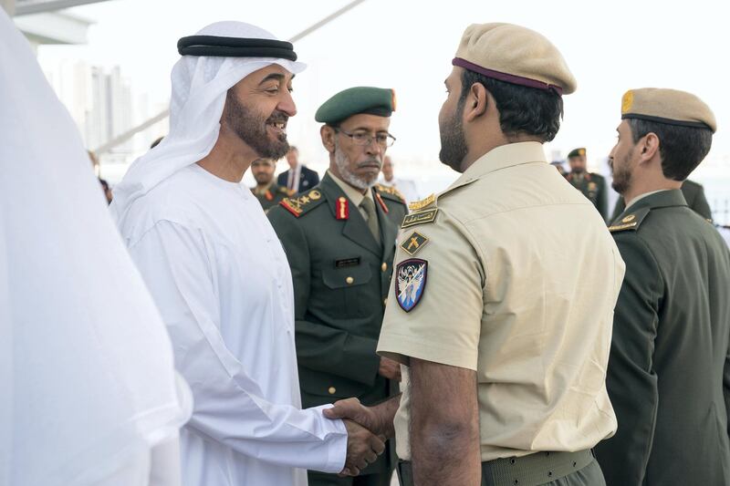 ABU DHABI, UNITED ARAB EMIRATES - March 5, 2018: HH Sheikh Mohamed bin Zayed Al Nahyan, Crown Prince of Abu Dhabi and Deputy Supreme Commander of the UAE Armed Forces (center L), presents a bravery medal to a member of the UAE Armed Forces, during a Sea Palace barza.
( Ryan Carter for the Crown Prince Court - Abu Dhabi )