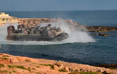 A U.S. amphibious hovercraft departs with evacuees from Janzur, west of Tripoli, Libya, Sunday, April 7, 2019. The United States says it has temporarily withdrawn some of its forces from Libya due to deteriorating security conditions. The pullout comes as a Libyan commander's forces advanced toward the capital of Tripoli and clashed with rival militias. A small contingent of American troops has been in Libya in recent years helping local forces combat Islamic State and al-Qaida militants and protecting diplomatic facilities. (AP Photo/Mohammed Omar Aburas)