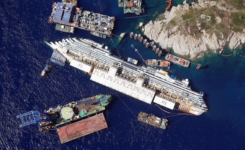 An aerial view shows the Costa Concordia as it lies on its side next to Giglio Island in Italy, taken from an Italian navy helicopter on August 26, 2013. Picture taken August 26, 2013. REUTERS/Alessandro Bianchi/File Photo SEARCH "POY DECADE" FOR THIS STORY. SEARCH "REUTERS POY" FOR ALL BEST OF 2019 PACKAGES. TPX IMAGES OF THE DAY.