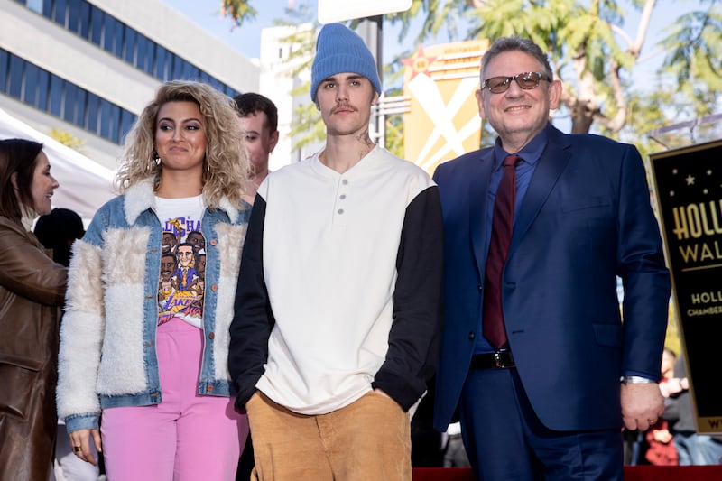 Tori Kelly, left, Justin Bieber, centre, in a Henley tee and beanie, and Sir Lucian Grainge attend a ceremony at the Hollywood Walk of Fame in Hollywood, California, on January 23, 2020. EPA-EFE