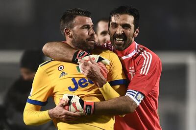 Juventus' defender Andrea Barzagli  and Juventus' goalkeeper Gianluigi Buffon (R) celebrate at the end of the Italian Tim Cup football match Atalanta vs Juventus on January 30, 2018 at the Atleti Azzurri d'Italia stadium in Bergamo.  / AFP PHOTO / MARCO BERTORELLO